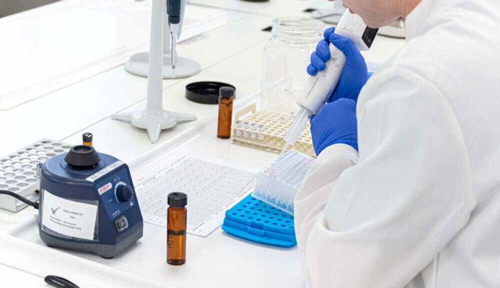 Pharmacodynamics Laboratory technician using pipette equipment