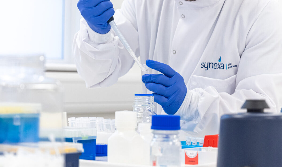 Scientist using pipette in laboratory