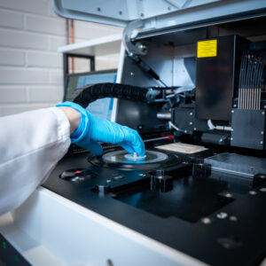 Hand operating scientific laboratory equipment.